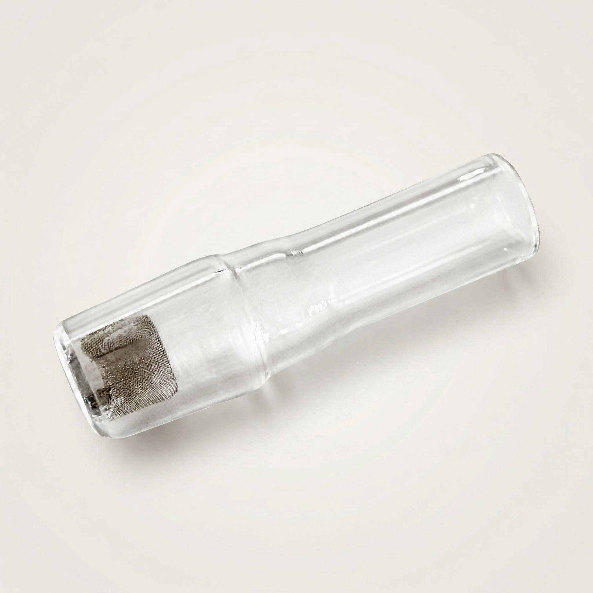 A close-up of a 12mm deep basket screen seated inside an 18mm male glass joint. This image shows how a basket screen can be used as a secondary debris catcher to help keep loose material out of the water piece and reduce mess downstream.