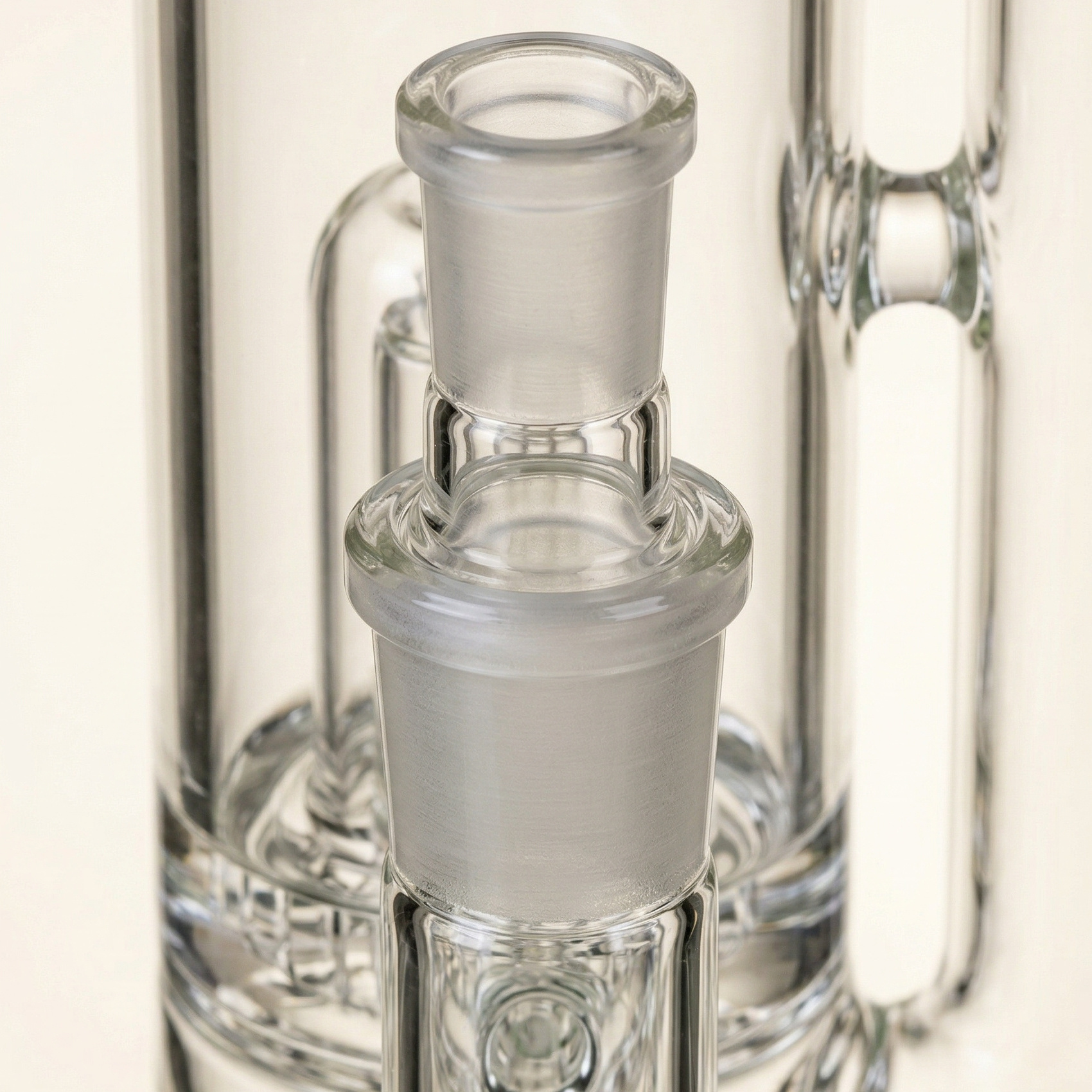 A close-up of an 18mm female glass joint fitted with an 18mm-to-14mm reducer. This image shows how larger 18mm glass can be adapted to accept smaller 14mm accessories, making it a useful example of why 18mm female glass is such a versatile starting point.