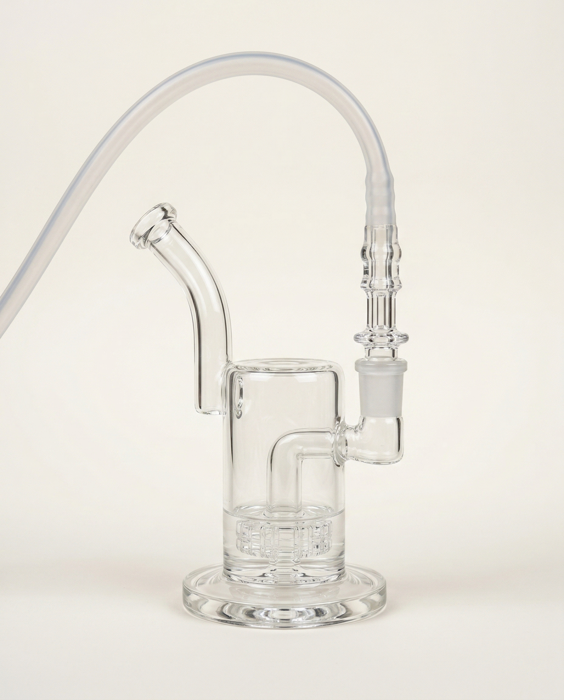 A glass whip-to-waterpipe adapter connected to a water piece with silicone tubing attached above. This image shows a common whip-based vaporizer setup, where vapor travels through the whip and into a glass joint instead of connecting directly through a mouthpiece adapter.